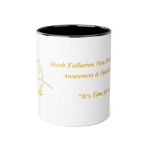 White mug with black interior and gold text on the side.